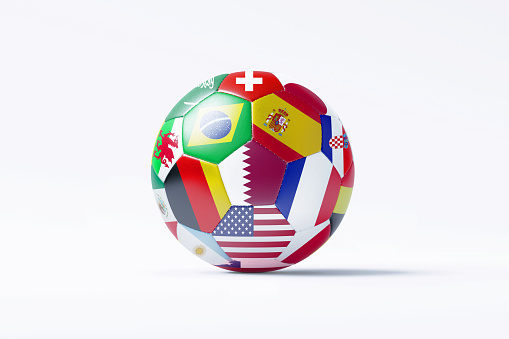 Soccer ball textured with national flags sitting on white background.  Horizontal composition with copy space.