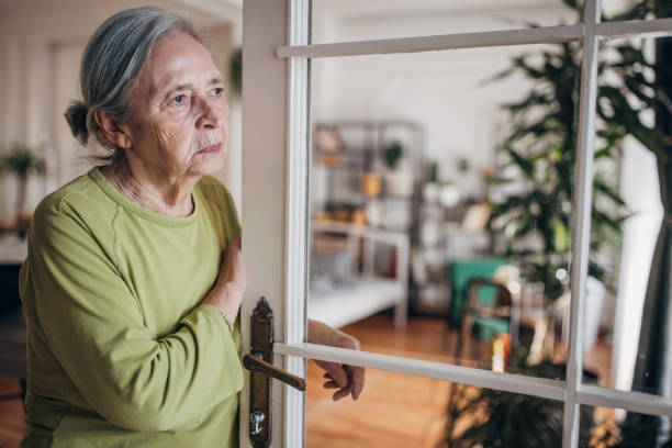 istock Elderly woman standing at the door 1440737057