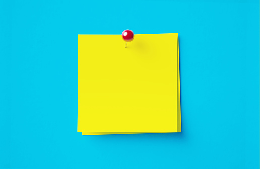 Yellow adhesive notes sitting on blue background. Horizontal composition with copy space.