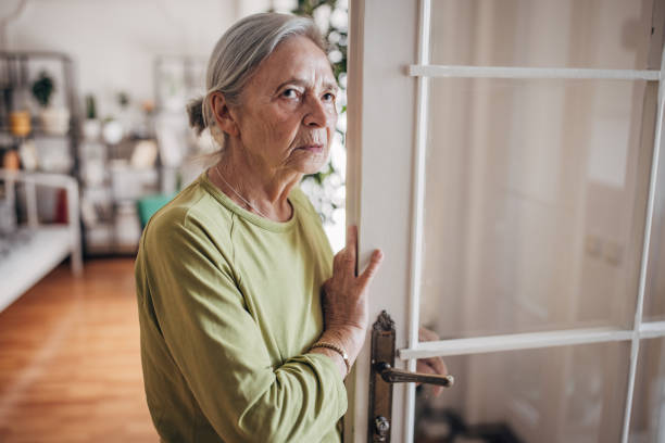 istock Elderly woman standing at the door 1440737263