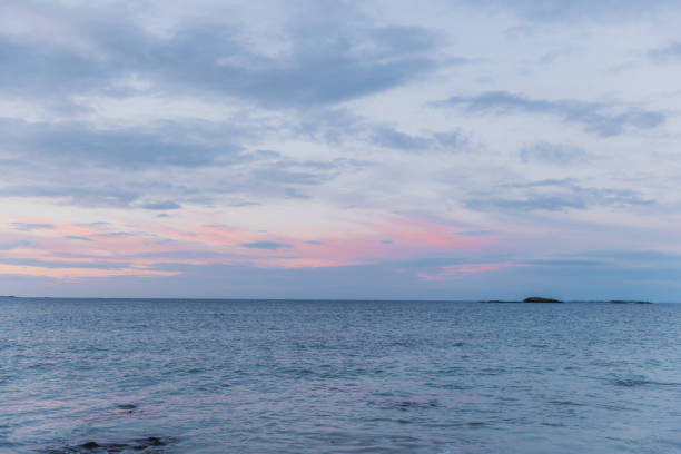 Scenic view of the bright sunset above the seashore and the islands in Norway