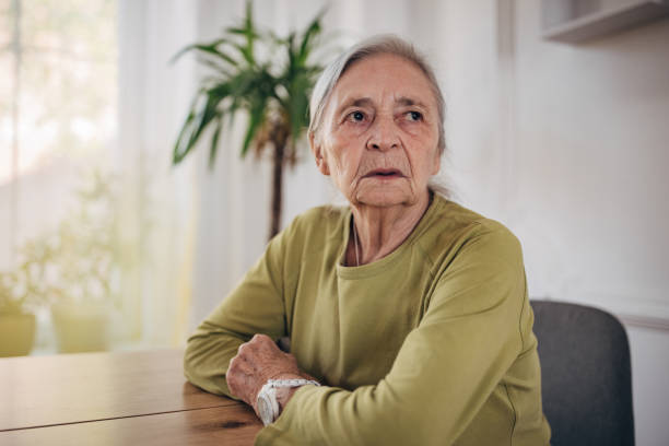 istock Elderly woman sitting at the dining table alone at home 1440737862