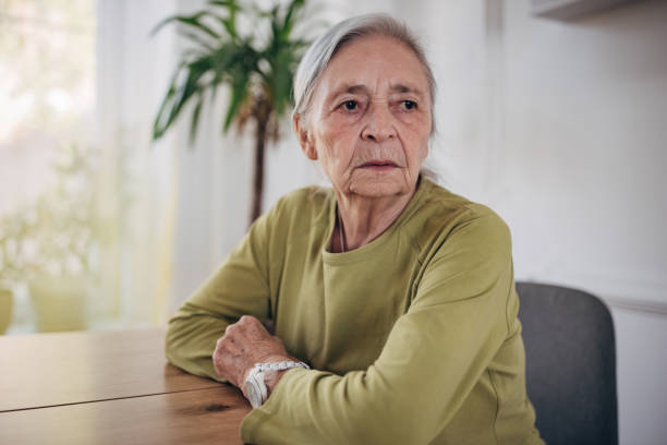 istock Elderly woman sitting at the dining table alone at home 1440737921