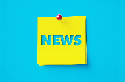 News written cut out yellow adhesive notes sitting on blue background. Horizontal composition with copy space.