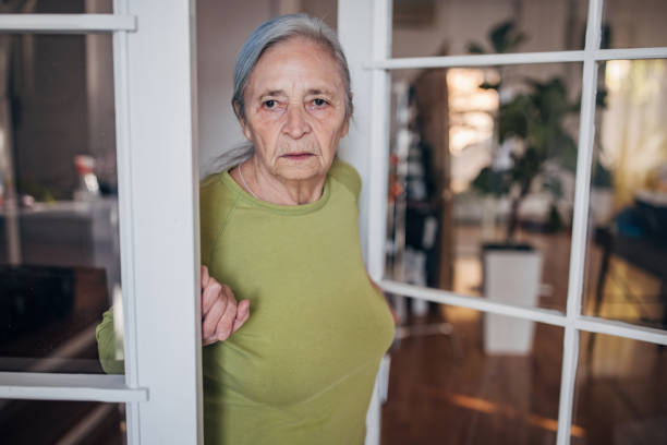 istock Elderly woman standing at the door 1440738027