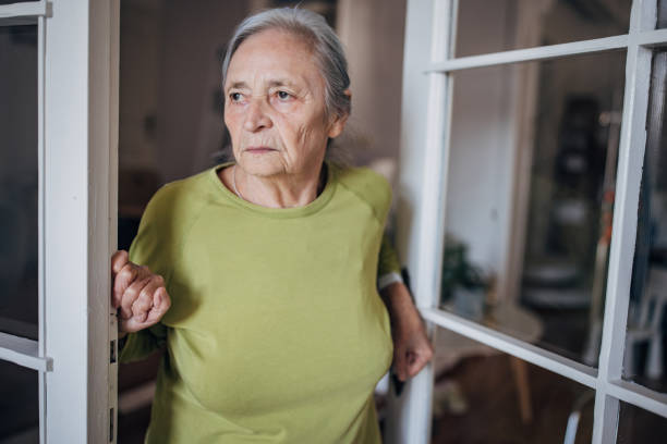 istock Elderly woman standing at the door 1440738067