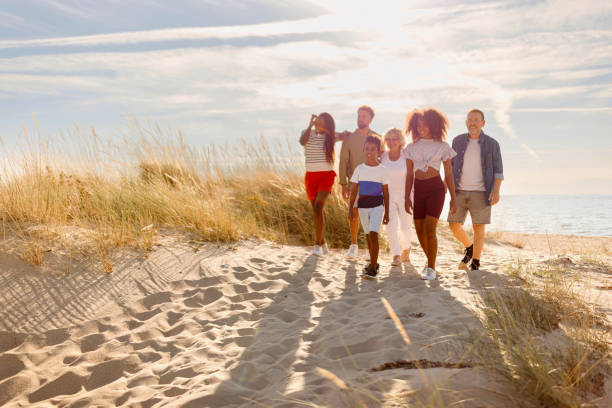 istock Multi-generation Family Walking Along Path Through Sand Dunes Together 1440739256