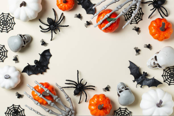 istock Halloween greeting card with bats, spiderweb, spider, skull and pumpkins 1440739884
