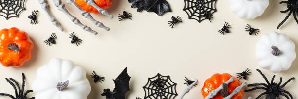 istock Halloween greeting card with bats, spiderweb, spider, skull and pumpkins 1440740219