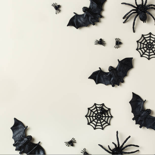 istock Halloween greeting card with bats, spiderweb and spider 1440740327