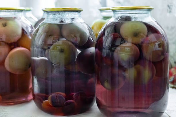 Jars with compote. Closed jars with fruit and juice
