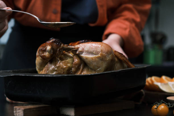 istock Preparing roasted chicken for Thanksgiving dinner 1440741239
