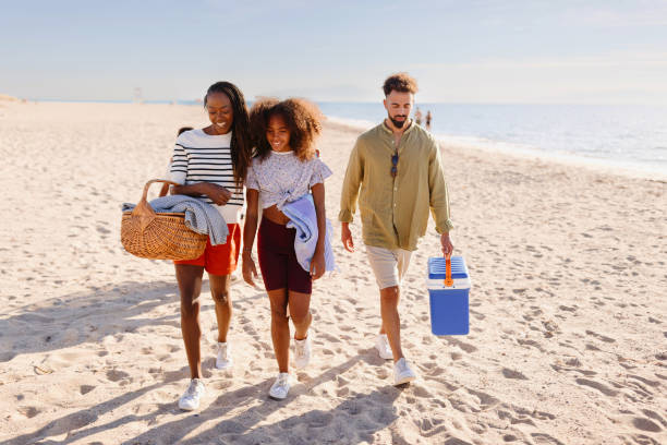 istock A multi-generational family walking on the beach carrying beach stuff 1440741852