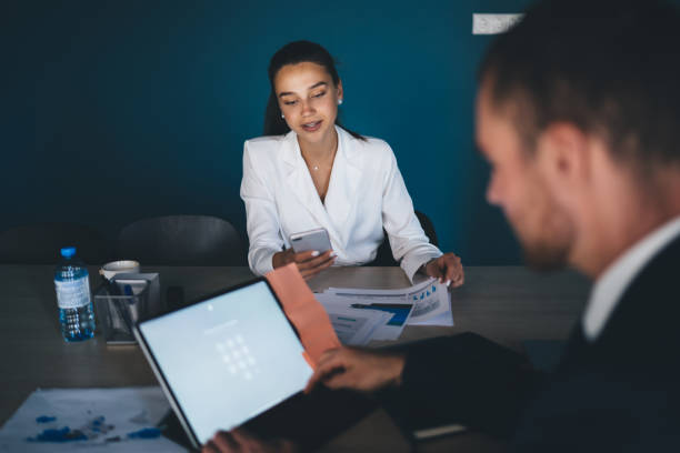 istock Confident female executive manager browsing smartphone in office 1440742433