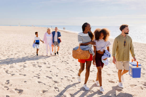 istock A multi-generational family walking on the beach carrying beach stuff 1440743228