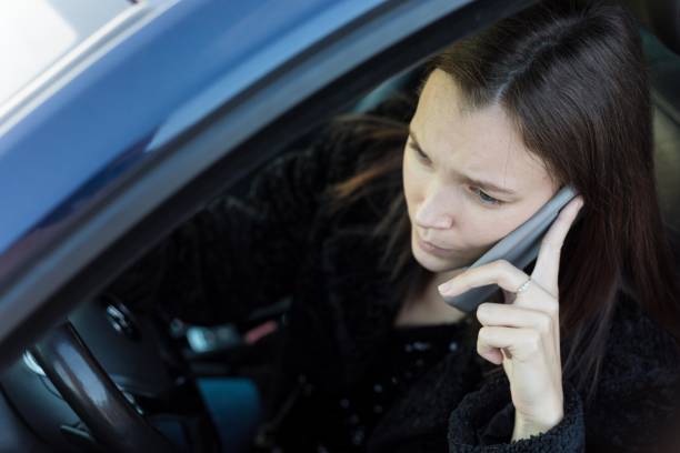 istock Distracted woman talking on her phone while driving. 1440744417