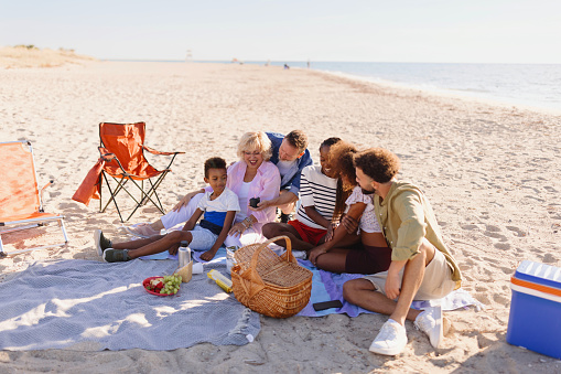 Multi generation family picnic on the beach
