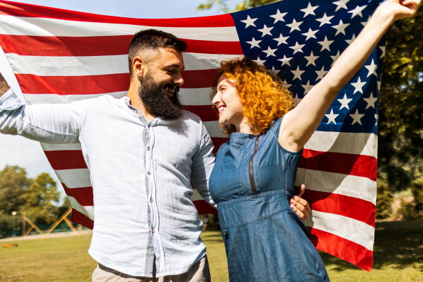 istock Young couple celebrating independence day at park 1440752459