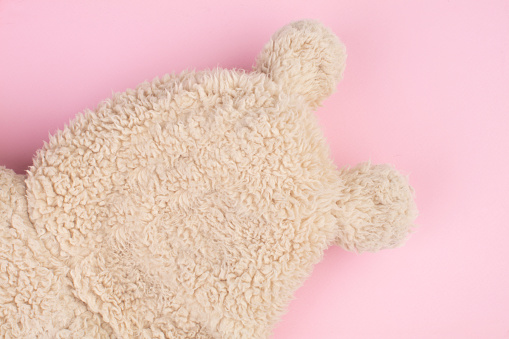 Funny bear made of fur on a pink background. Abstract bear.