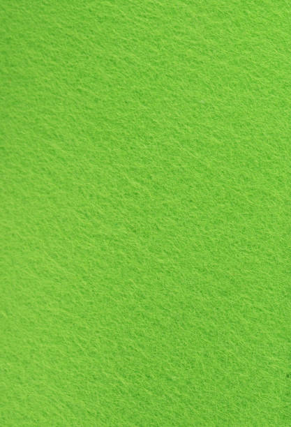 istock Full frame in short pile green felt, vertical arrangement. 1440753322