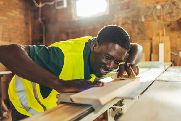 istock Male carpenter working on a wood in a retro vintage workshop. 1440753624