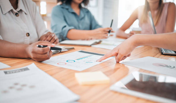 istock Business, marketing analytics and finance team discussing data with collaboration and teamwork in a office. Closeup staff working on tax, audit report and accounting infographics documents together 1440753686