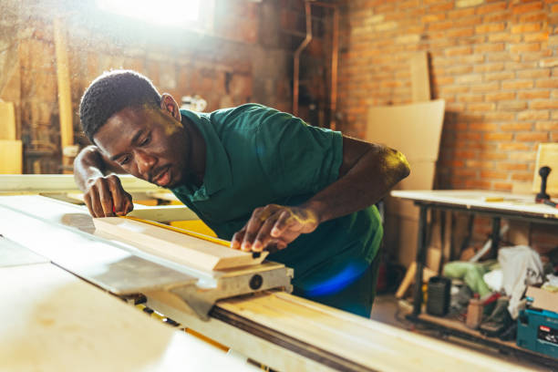 istock Manual worker hands working with a measuring tape in wood plank 1440753739