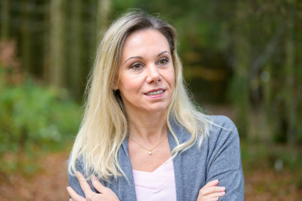 istock Woman with crossed arms in a forest 1440754629