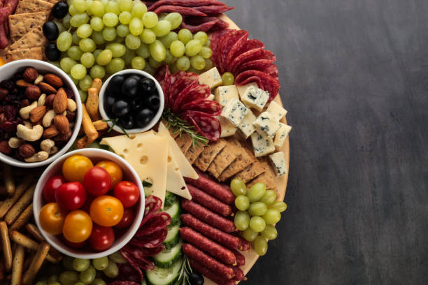 Charcuterie Gold meat plate, charcuterie on a dark background with copy space. The traditional Spanish choice is Tapas. chopping board stock pictures, royalty-free photos & images