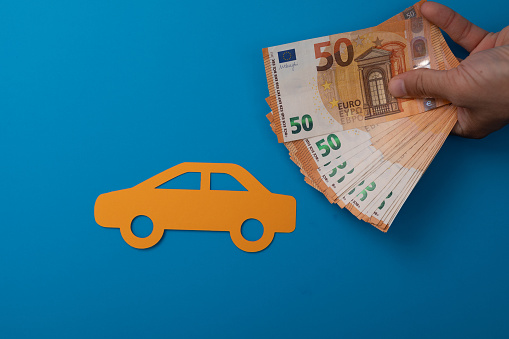 A top view shot of a car sticker and 50 euro banknotes