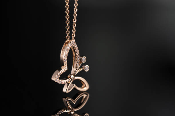 istock Selective focus closeup of gold necklace on a black background 1440761338