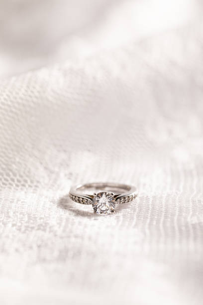 istock Vertical shot of a beautiful diamond ring on a white surface 1440761399