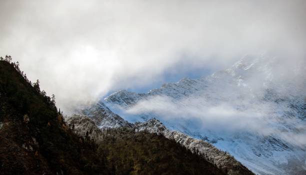 istock Peaks of mountains covered with clouds 1440762526