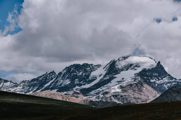 istock Snow-capped mountain range under a cloudy sky at the Gran Paradiso National Park in the Italian Alps 1440762827