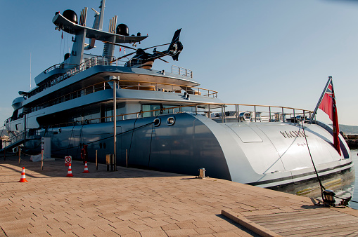 olbia, Italy – August 14, 2014: A front view of a big yacht with a helicopter at the port of Olbia in Italy