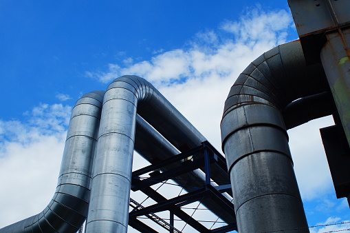 A stack of metal pipes with one protruding. Very high resolution 3D render.