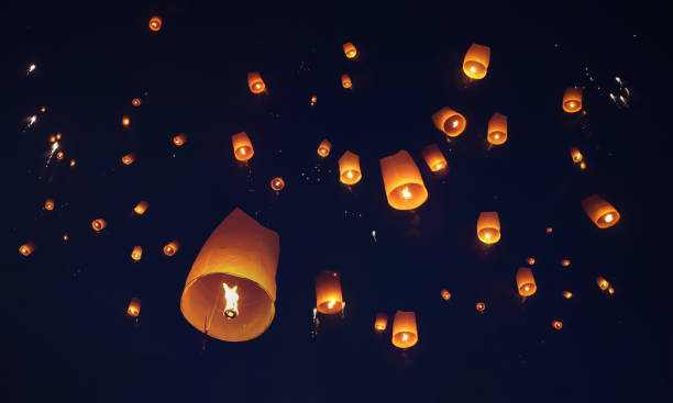 solte as tradicionais lanternas de papel no céu durante a noite do festival na tailândia. - voo de cerimónia - fotografias e filmes do acervo