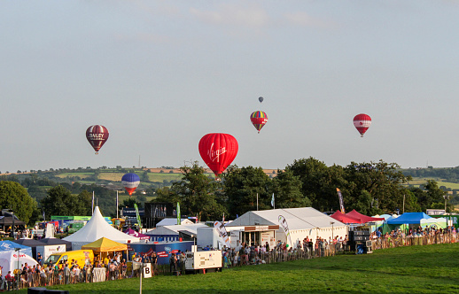 Bristol, United Kingdom – August 09, 2012: A panoramic shot of hot air balloons flying above the scenes of the Bristol Balloon Festival