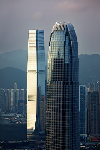 Hong Kong, Hong Kong – August 05, 2020: A vertical shot of  Hong Kong's famous ICC and IFC skyscrapers next to each other during a sunset