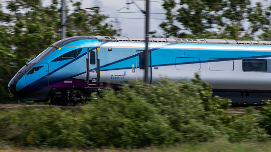 Cramlington, United Kingdom – June 24, 2021: A closeup of a high speed train passing through Cramlington on the East Coast Main Line in England