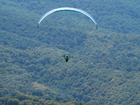 Siria, Romania - July 23 2022: Paraglider over Siria fortress. Siria fortress is a medieval fortress dating back to the XIII century located in the village of Siria, Arad county