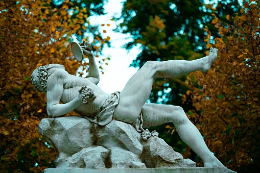 The Mozart statue and the red flowers garden Burggarten, Vienna, Austria.