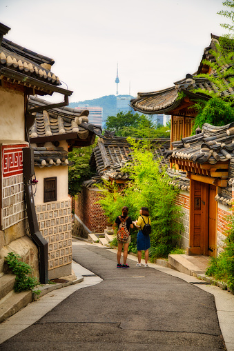 Seoul, South Korea – September 03, 2016: Two women walk through an alley in the Bukcheon village in Seoul, South Korea