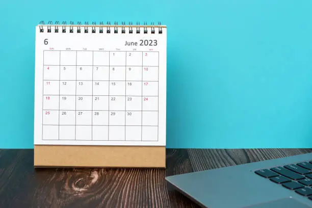 Photo of June 2023 desk calendar on top of table