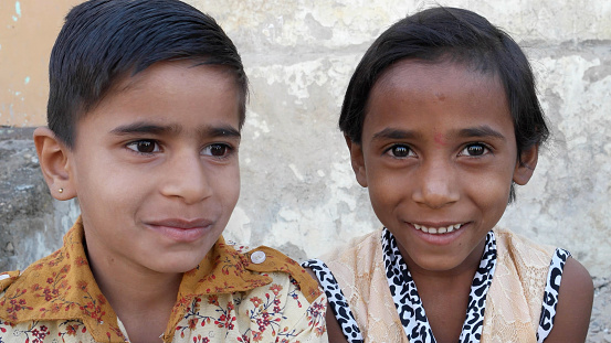 Indian poor children looking at the camera and smiling