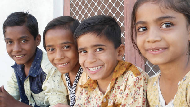 A group of Indian siblings smiling and looking at the camera