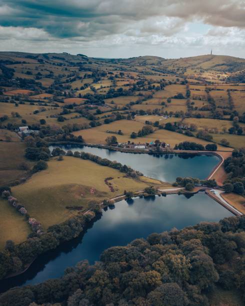 istock Aerial view of greenery fields surrounded by dense trees and water 1440767830
