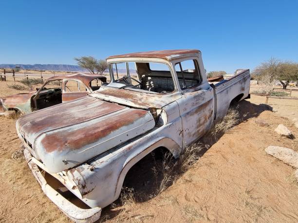 istock Old broken vintage car thrown in a desert 1440768153