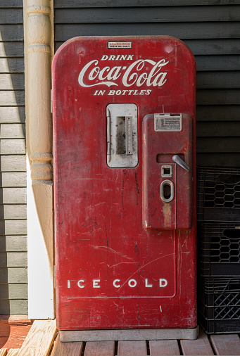 Stowe, VT - 6 October 2022: Antique refridgerated Coca Cola bottle dispenser