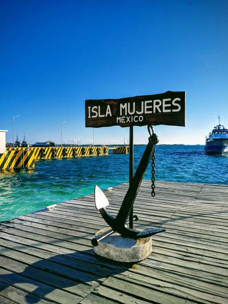 "Isla Mujeres" wooden banner decorated with an anchor on the beach An "Isla Mujeres" wooden banner decorated with an anchor on the beach isla mujeres stock pictures, royalty-free photos & images